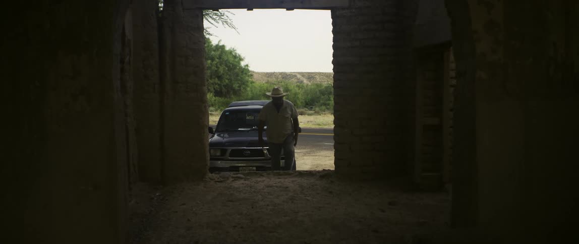 A man walking into a barn