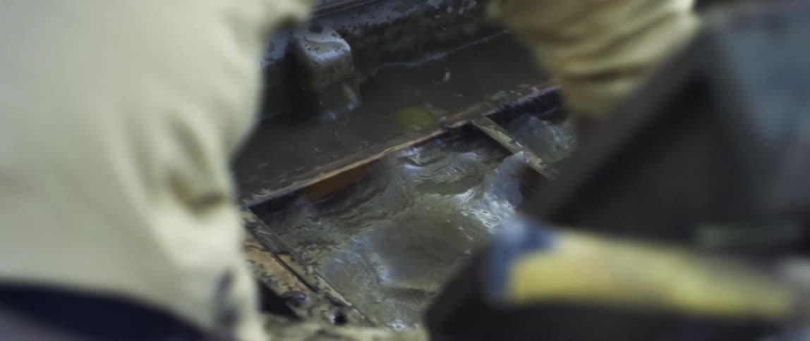 Person scrubbing metal