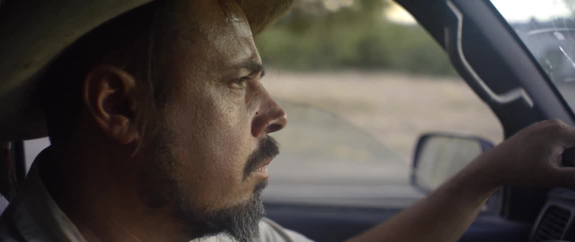 A man driving a vehicle down a road