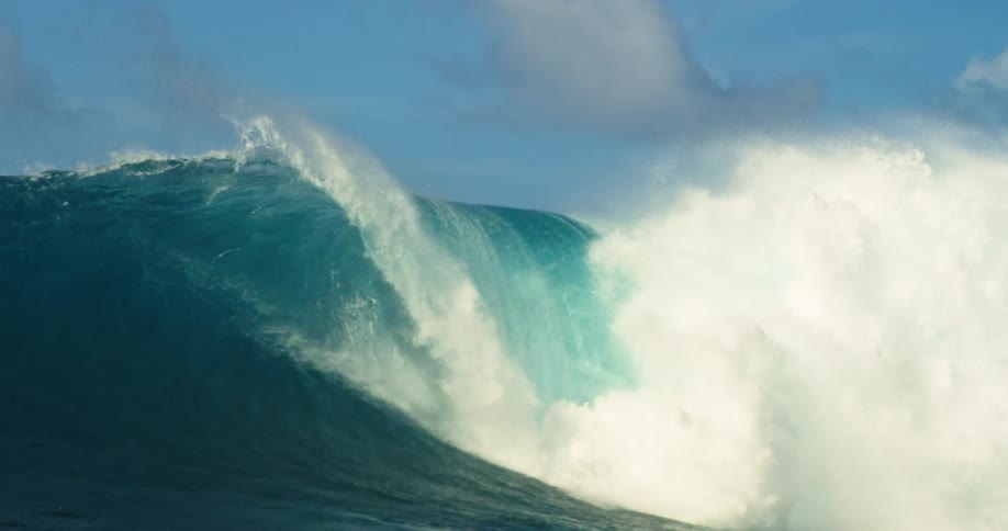 A large wave crashes in the ocean