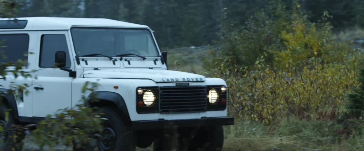 A land rover driving down a rural road