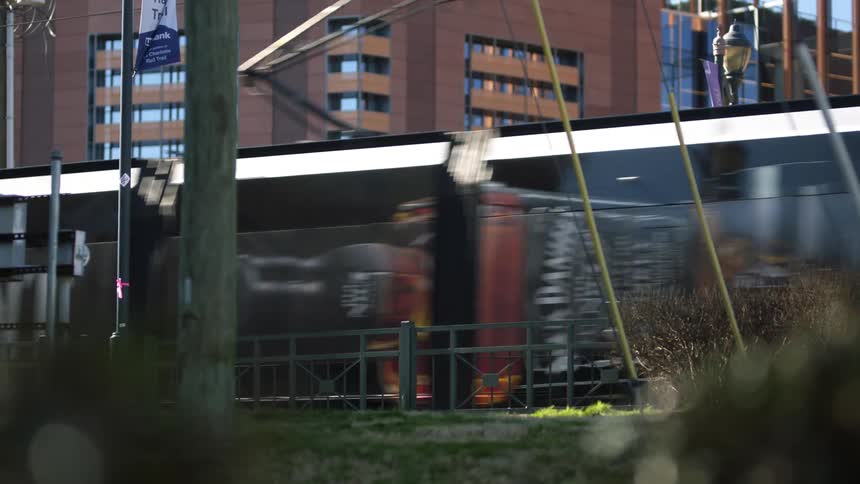 A light rail train driving by