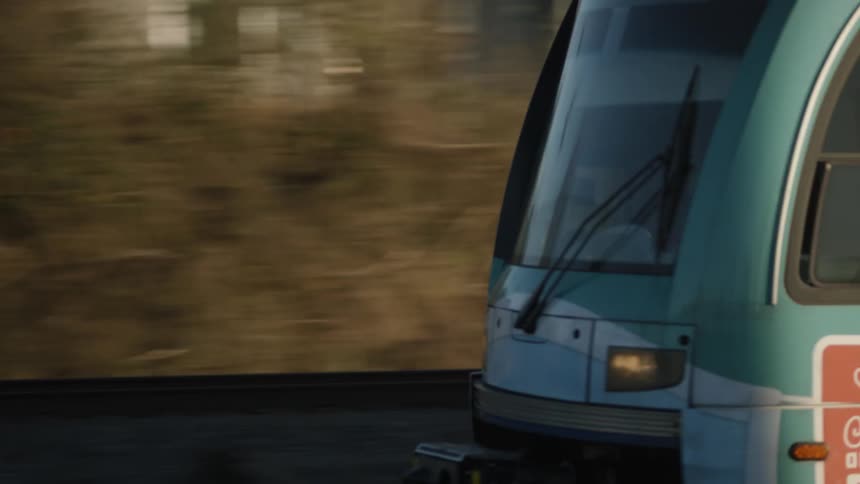 Train travels along metal tracks and carries people