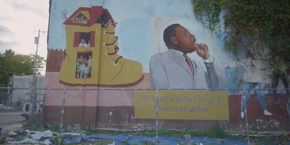 A martin luther king mural behind a fence