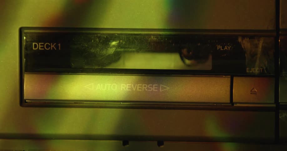 Colored light from prism and shadows flow over tape deck