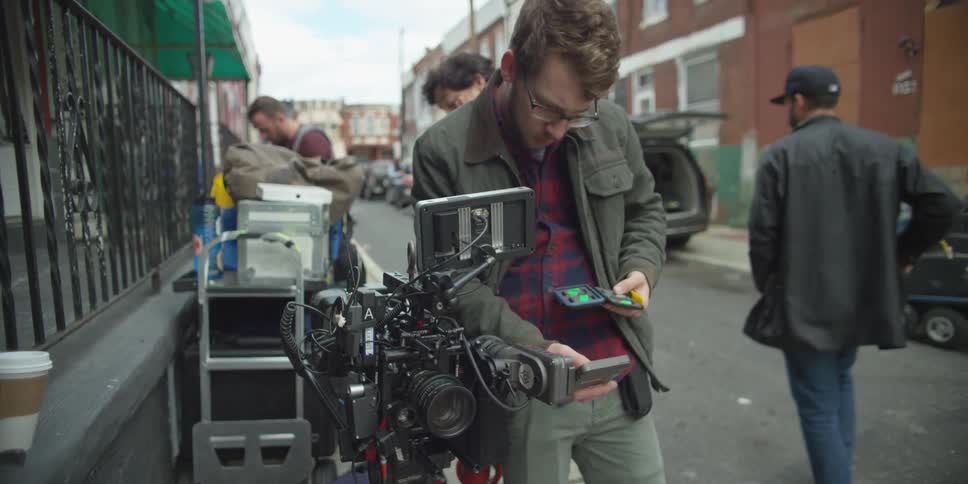 A man adjusts a camera