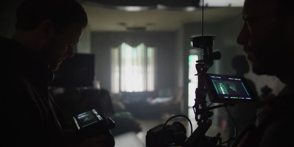 Two men filming a room