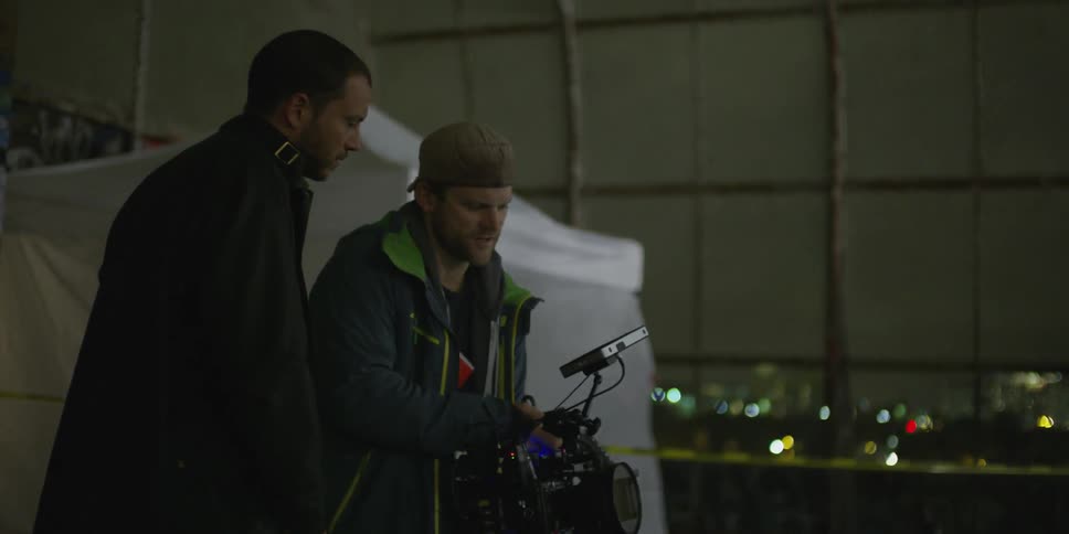 Men filming something at night