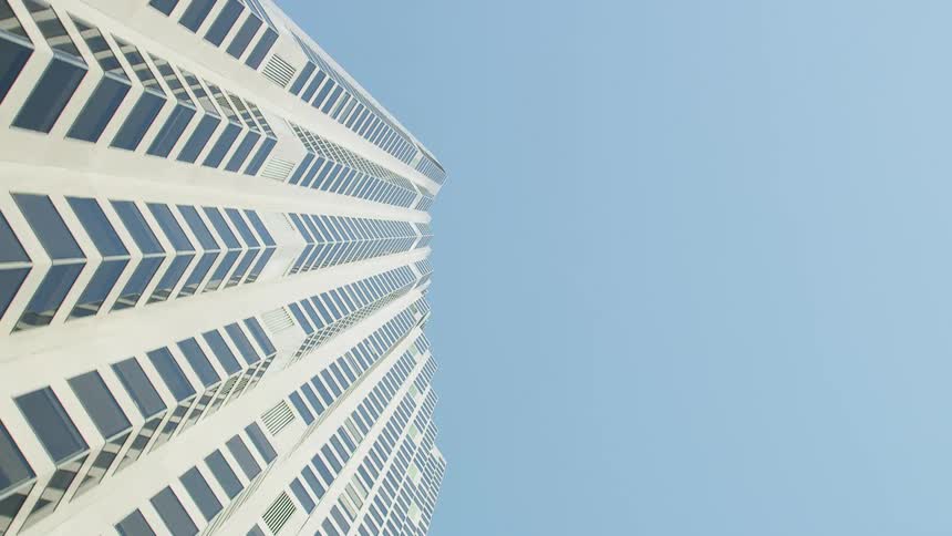 Tall skyscraper reaching high into a clear blue sky