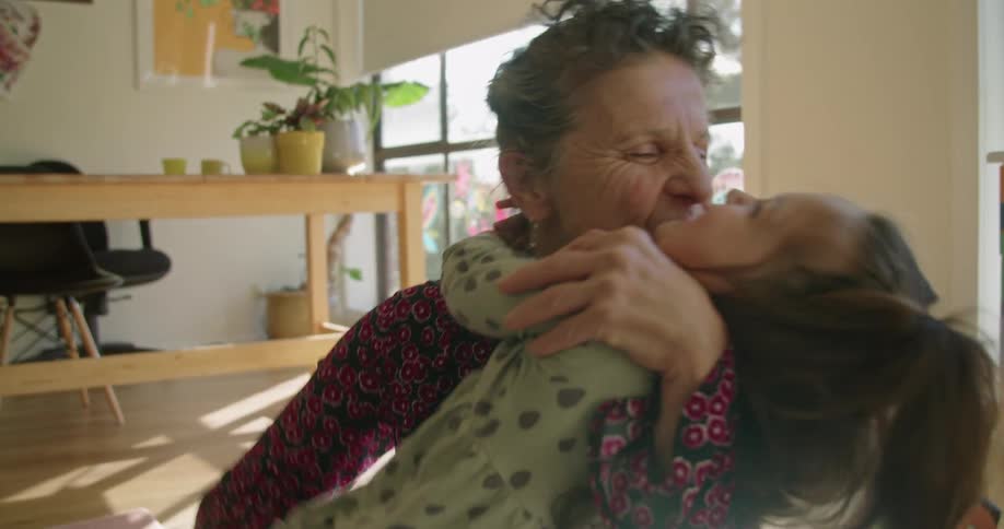Grandmother and child hugging excitedly