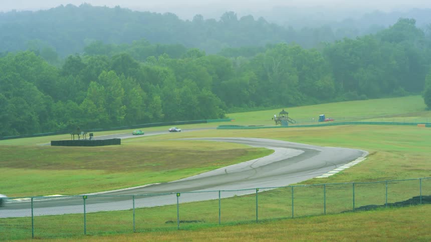 Race officials wave black flags at the curves as race cars pass