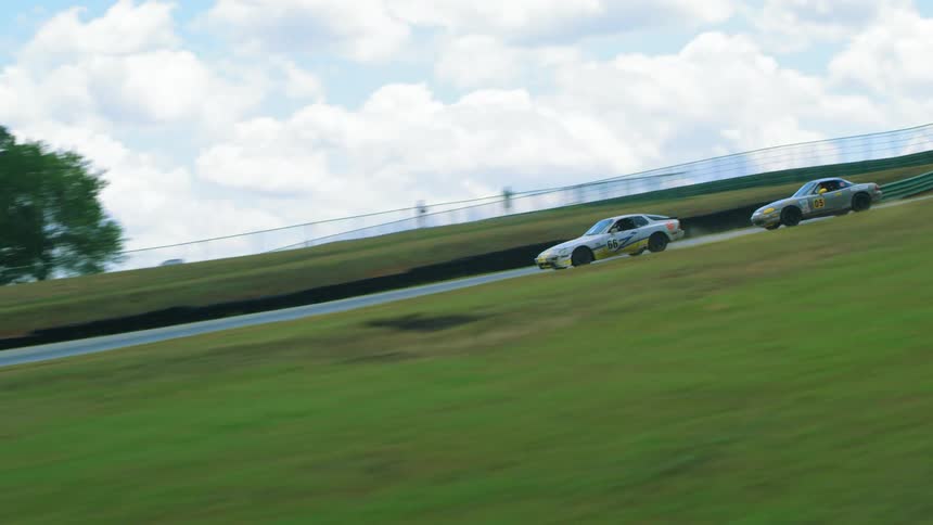 People race cars around a track during a race