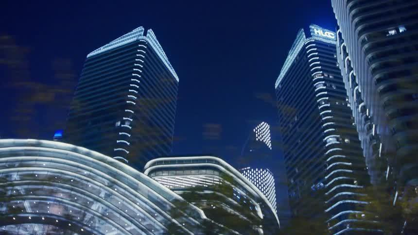 Illuminated high rise buildings against against the dark sky
