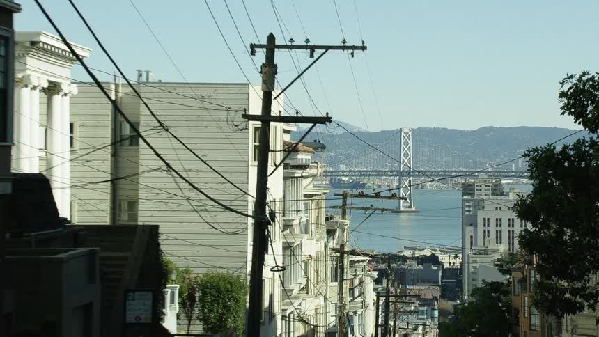 A neighborhood sits on a hill leading down to the ocean