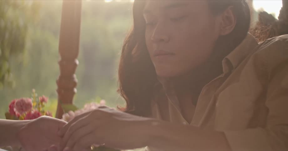 Two women lovingly caress each others hand