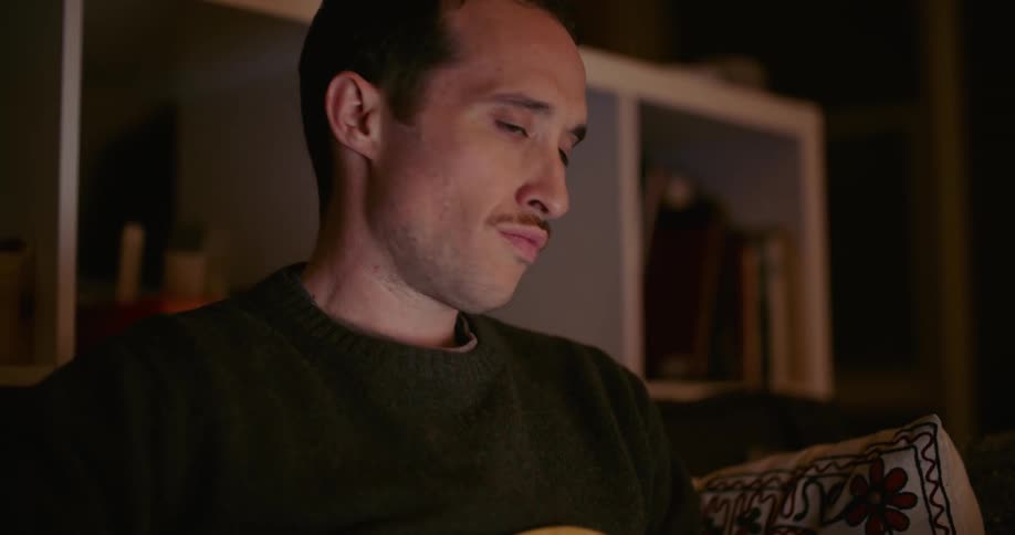 A view of a man playing a guitar