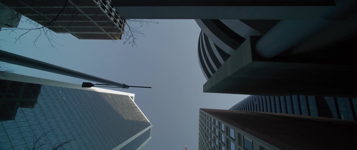 The sun shines on the tall buildings