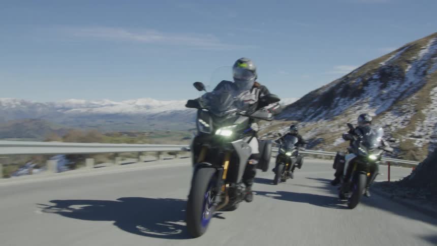 People ride their motorcycles on the mountain road