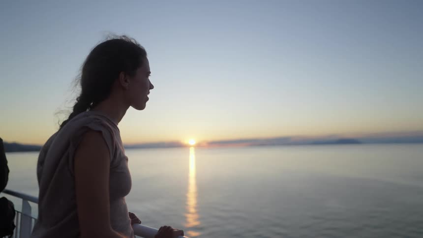 A girl watches the sunset