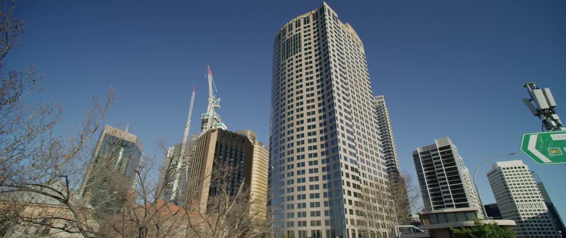 Construction cranes sit among buildings in downtown tower block