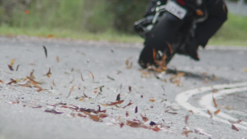 A person turns on the road with their motorcycle
