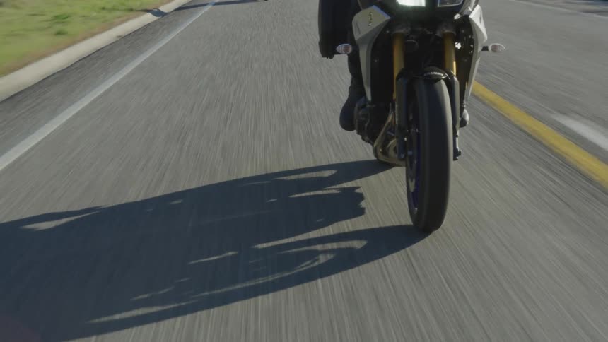 Biker rides motorcycle on highway