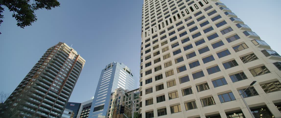 An urban city with tall skyscrapers is displayed in spring