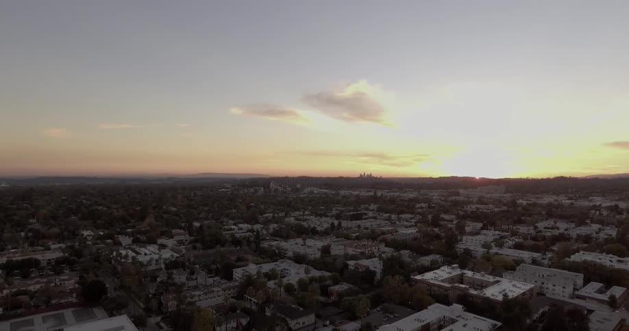 The sun rises over a city