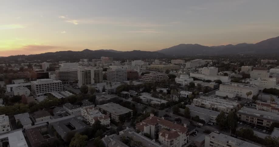 The sun sets over city buildings
