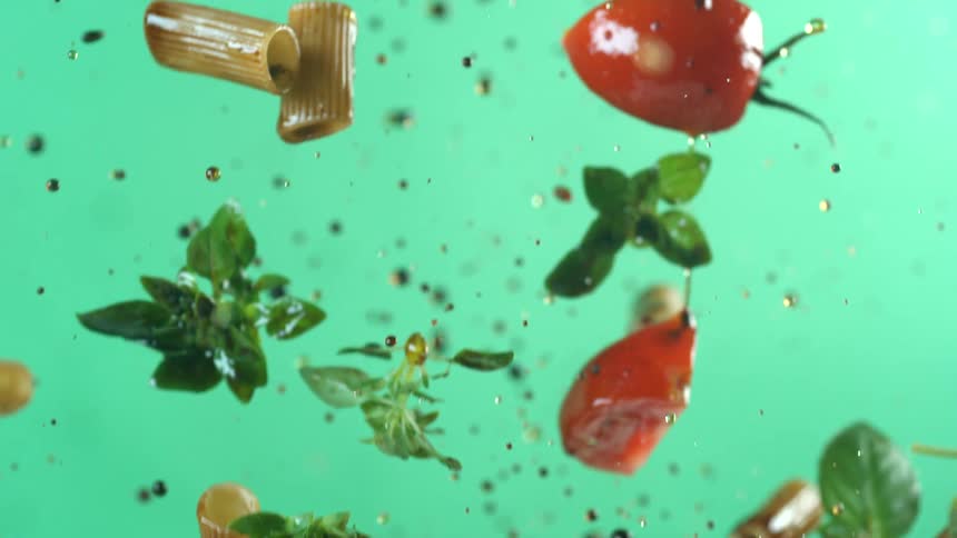 Pasta and tomatoes rising and falling in the air at a studio