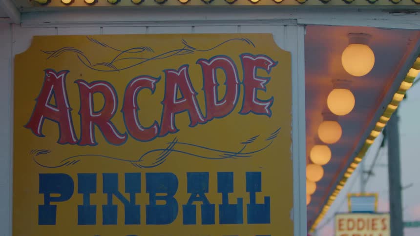Pinball arcade sign with flashing lights at a carnival
