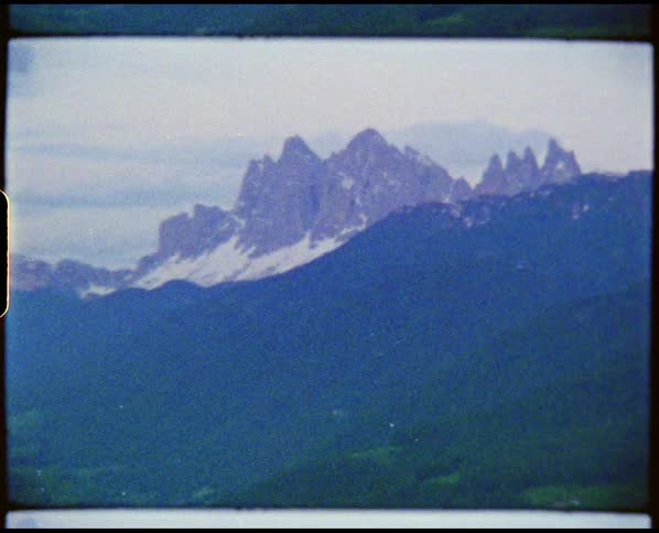 A person is looking at snow covered mountains from a distance