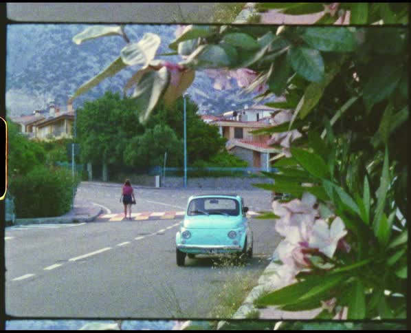 A woman walks down the street in town