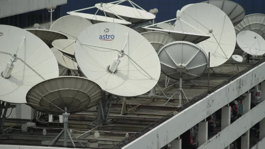 Satellite dishes crowd roof of parking garage
