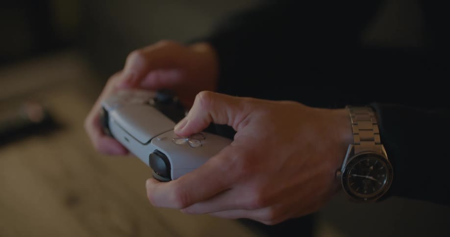 A person is pushing buttons on a video game controller