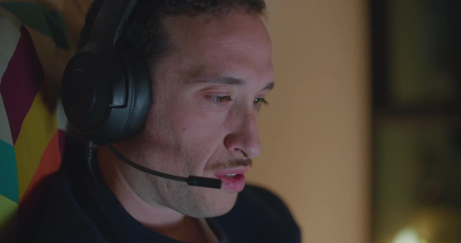 A man talking on a headset and laughing
