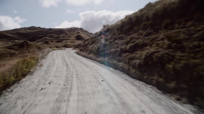 Traveling on a dirt road in the wilderness on a cloudy day
