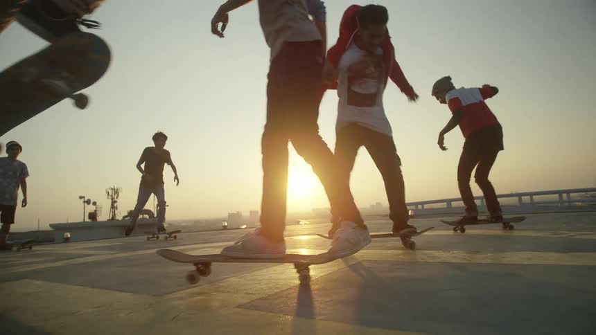 Skateboarders are doing tricks on the roof