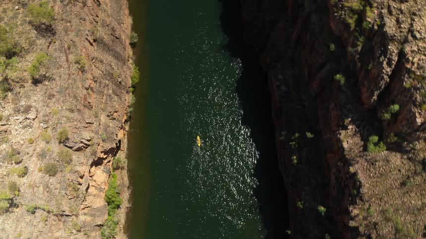 A boat in a river canyon