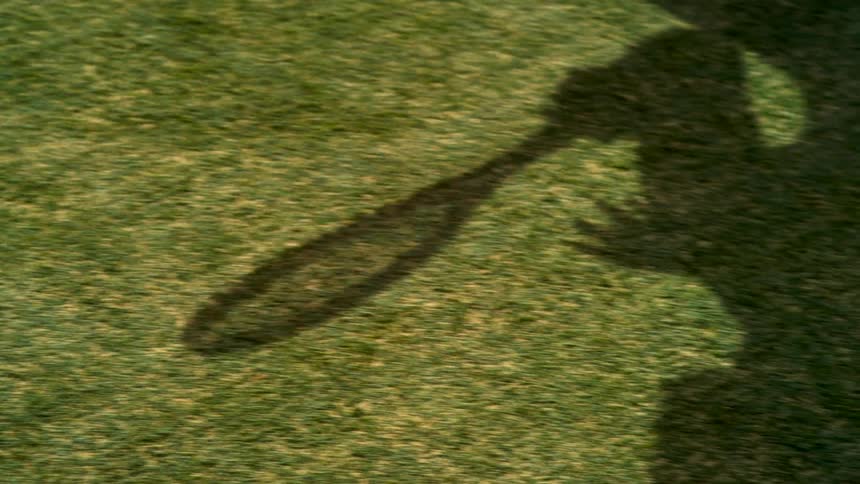 Shadow of a tennis player ready to hit the ball