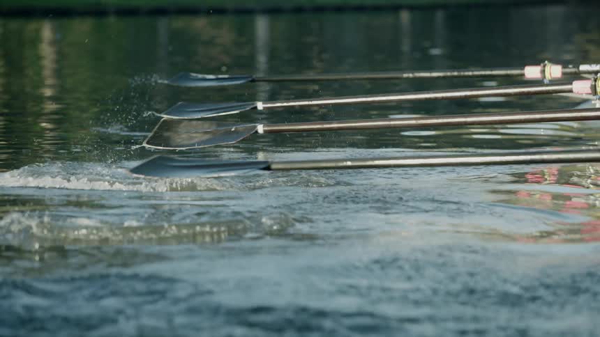 A woman acts as coxswain for a rowing team