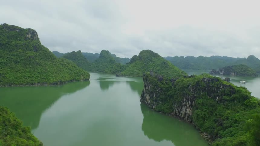 Aerial view of the green waters of a lake in the mountains