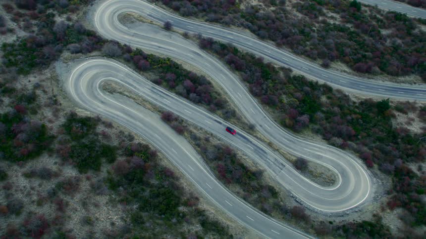 A car is driving around the tight turns on the race track