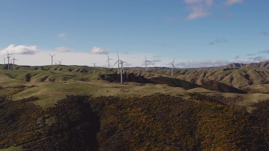 Wind turbines on the hilly countryside under a blue sky