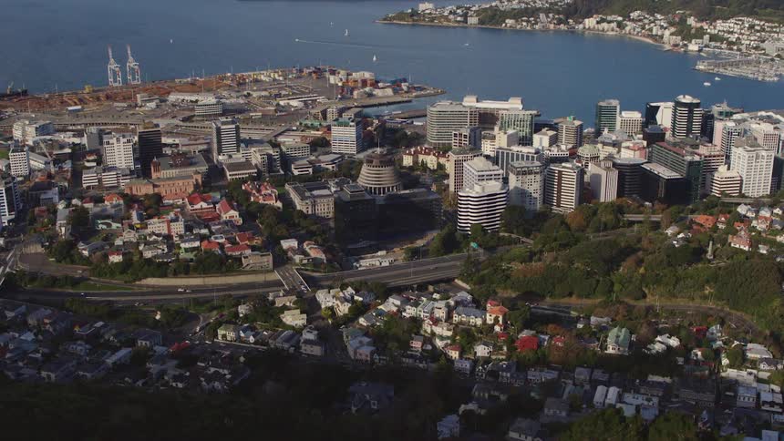 A busy highway separates a dense neighborhood from downtown