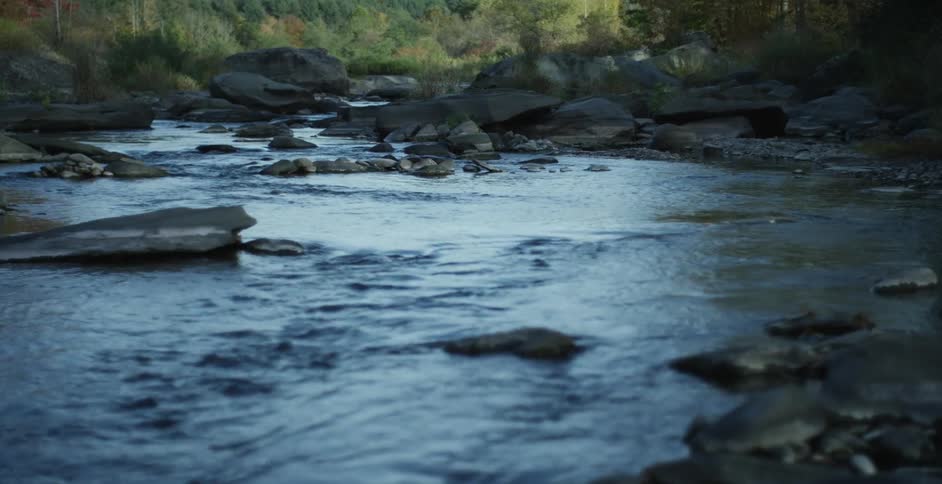 Water is moving down a rocky stream