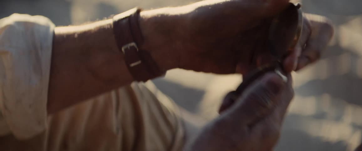 A man opening a compass outdoors