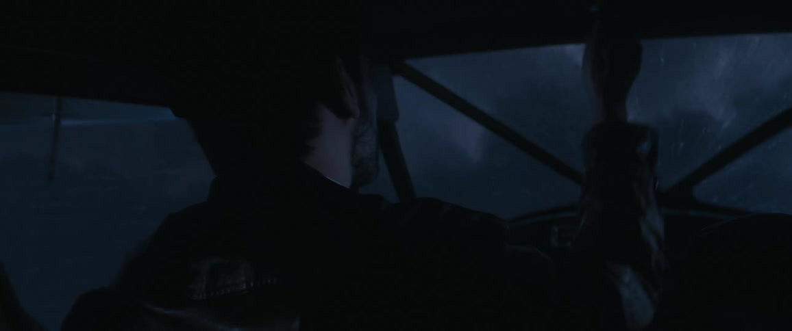A man flying a plane through the clouds at night