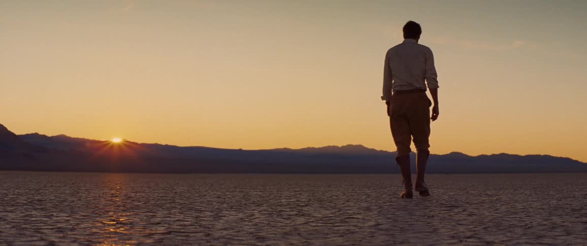 A view of a person walking on a dry lake bed