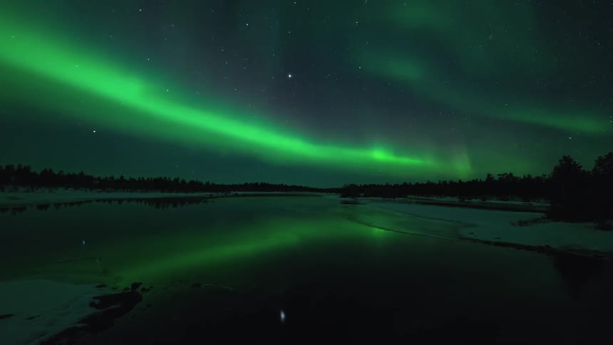 Magical northern lights over an icy flowing river